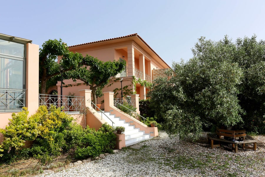 on side of entrance 'Eleonas' building with trees on the both sides